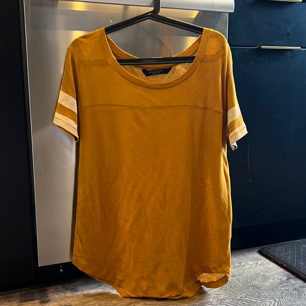 Knot Sisters hand stitches marigold tee with white stripes.